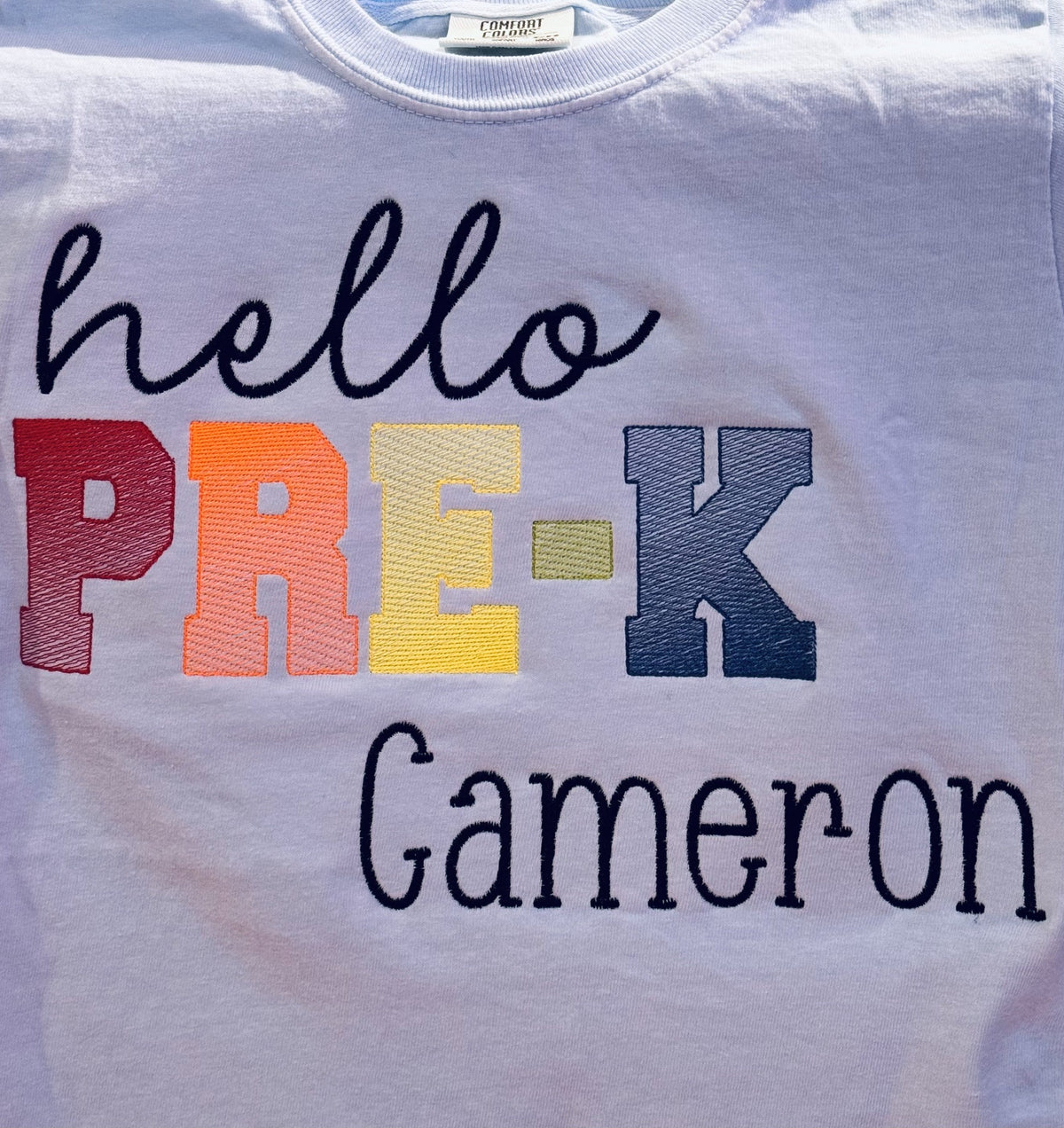 Light shirt reading Hello Pre-K personalized with the name Cameron