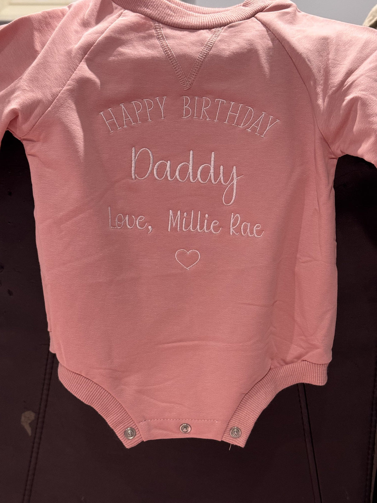 Pink baby bodysuit embroidered with a Happy Birthday Daddy message