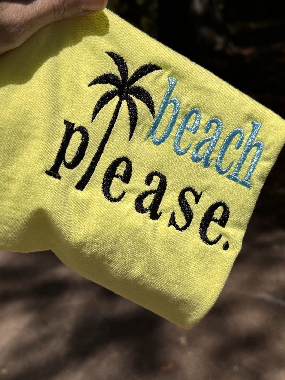 Bright yellow T-shirt embroidered with Beach Please lettering and palm tree motif