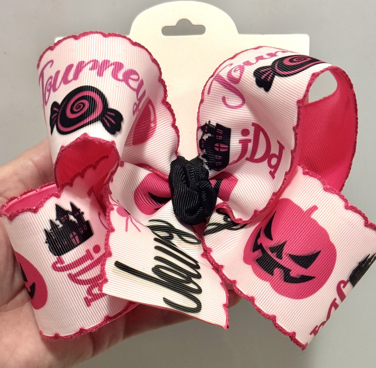 Personalized layered fabric bow with pink black and white printed details