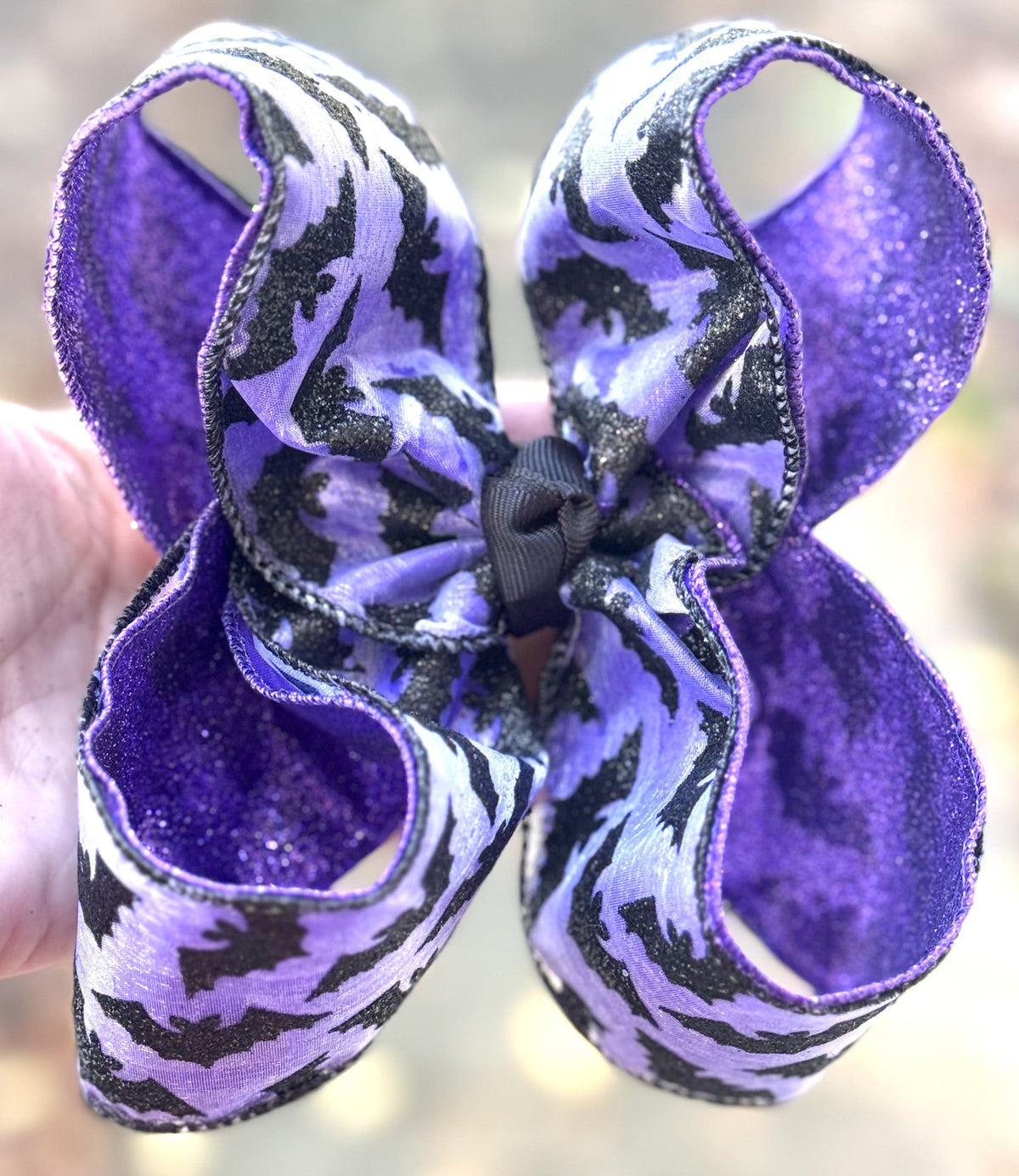 Purple and black patterned handmade bow with layered ribbon loops