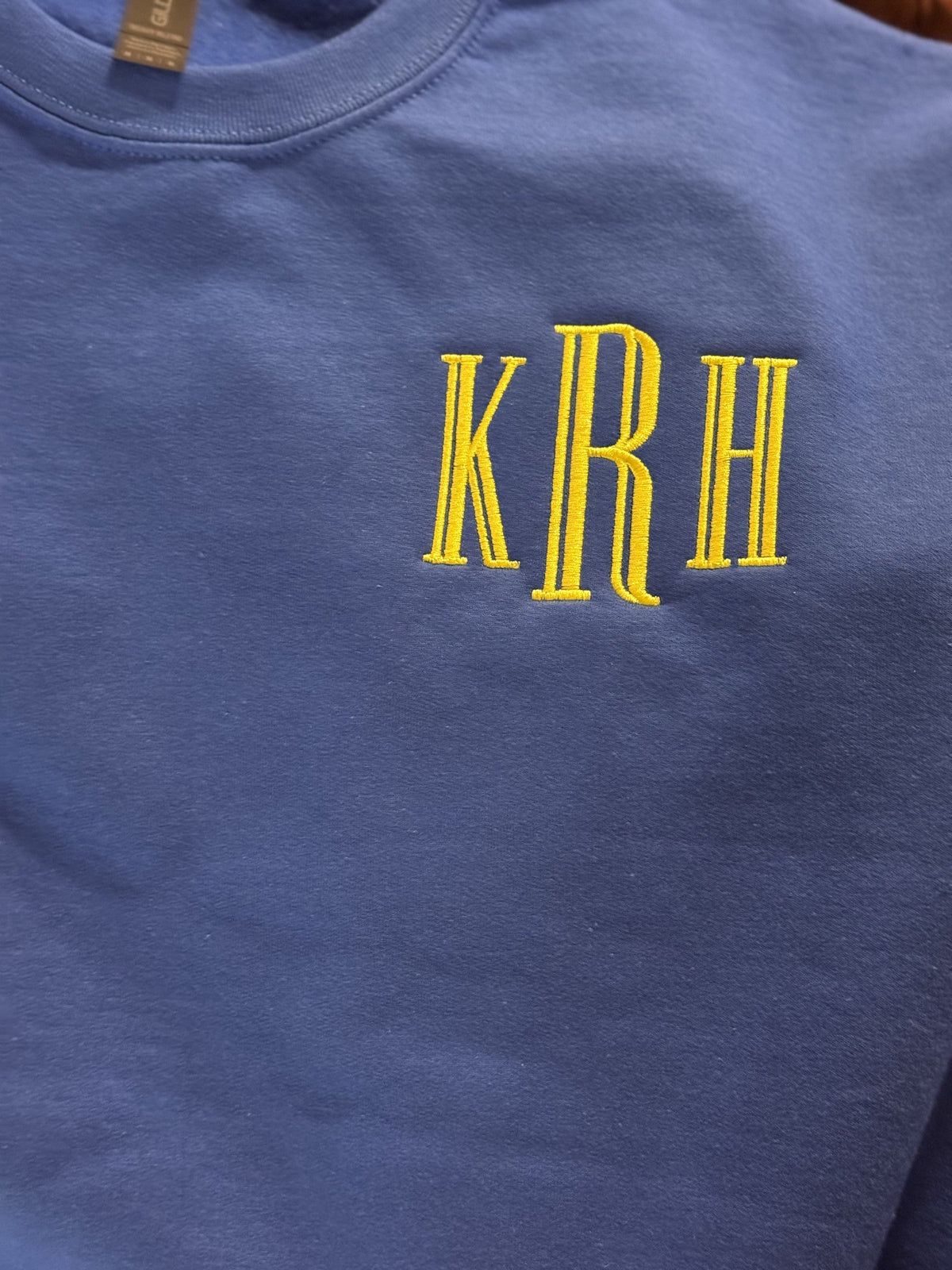 Blue shirt embroidered with tall yellow KRH monogram lettering