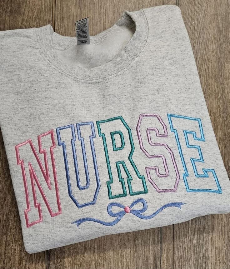 Gray sweatshirt with large pastel NURSE applique lettering