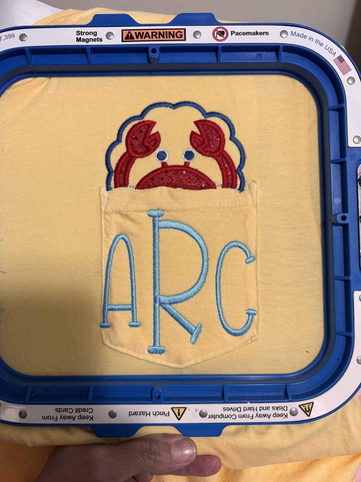 Yellow shirt with bulldog mascot applique and ARC monogram embroidery