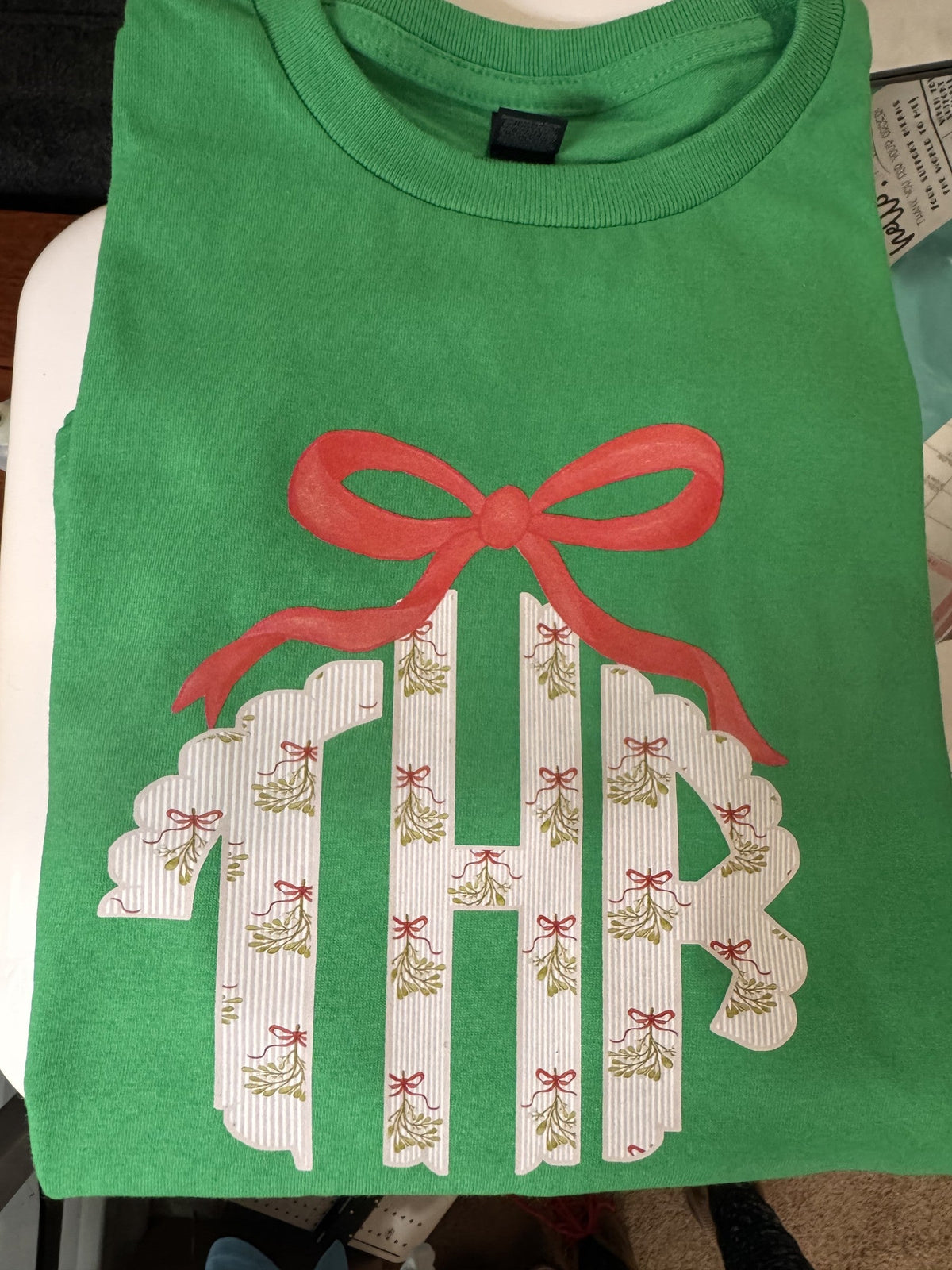 Green shirt with gift-shaped holiday applique and personalized monogram