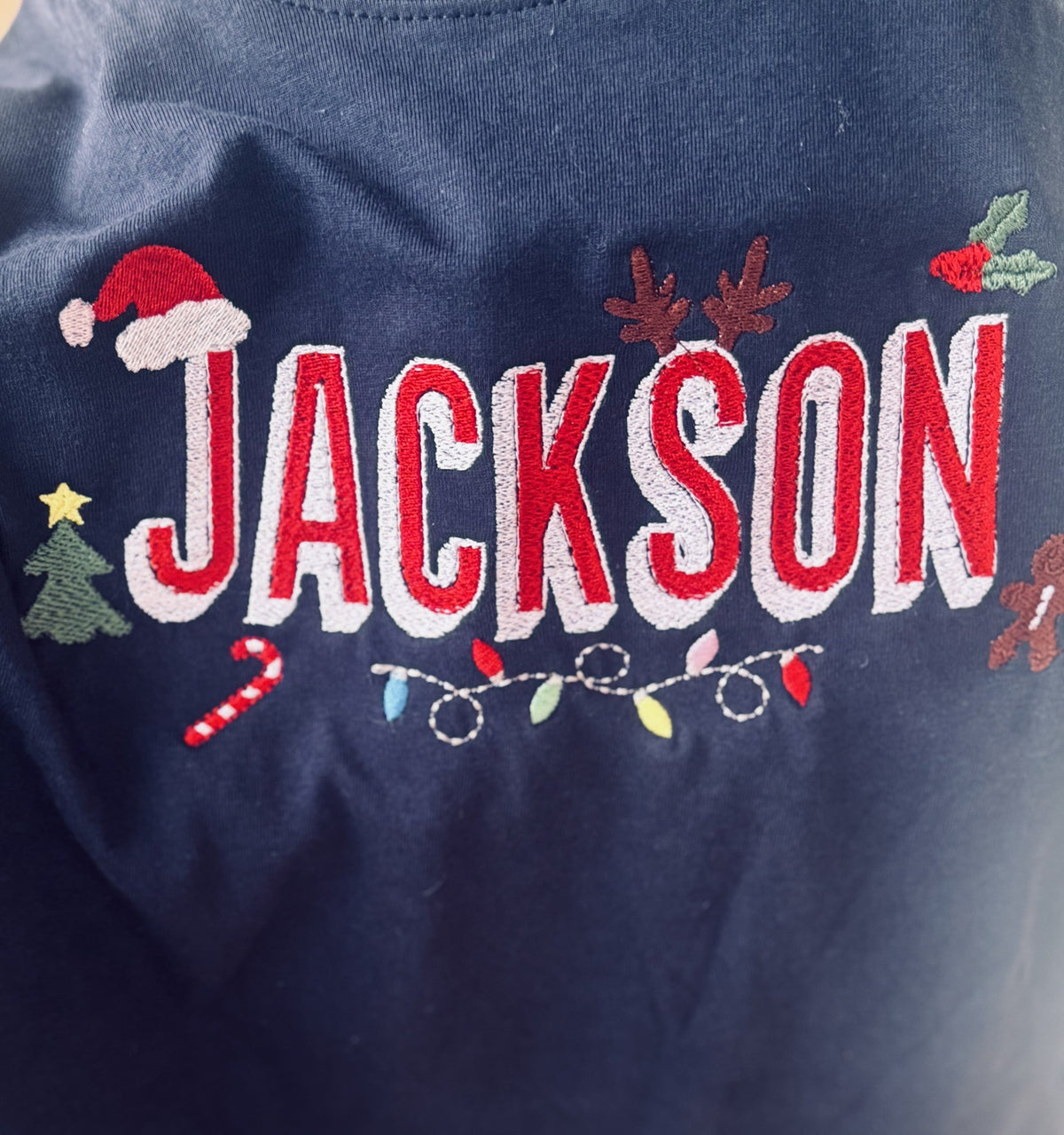 Navy sweatshirt personalized with the name Jackson and Christmas icons