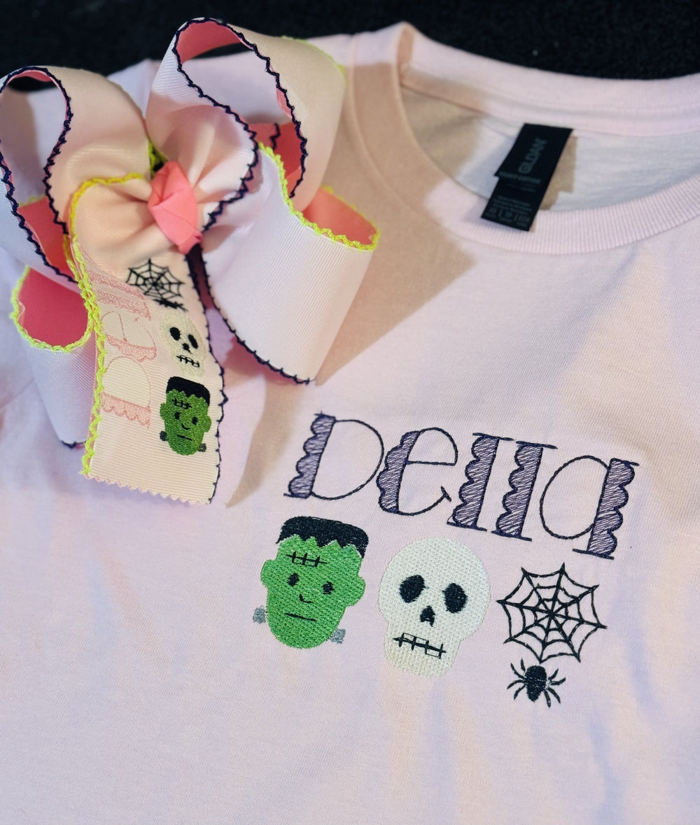 White Halloween-themed embroidered shirt displayed with a coordinating bow