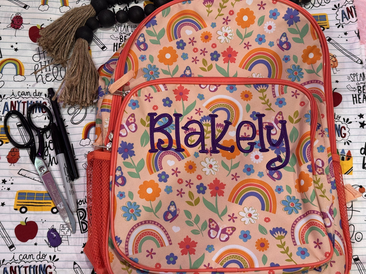 Colorful rainbow backpack personalized with the name Blakely
