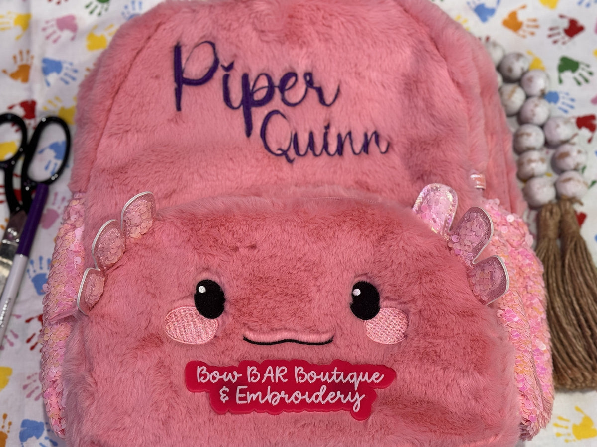 Pink axolotl backpack personalized with the name Piper Quinn