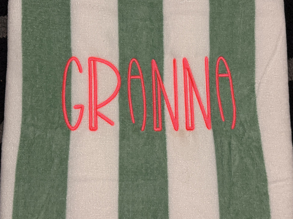 Green and white striped towel personalized with the name Granna