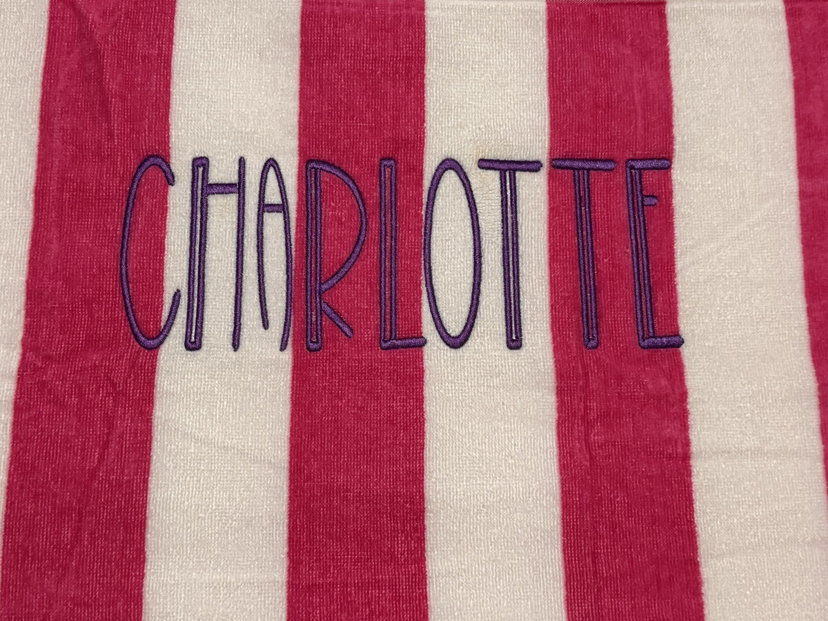 Pink and white striped towel personalized with the name Charlotte