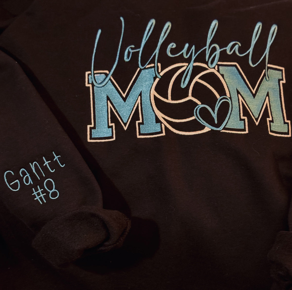 Dark sweatshirt with Volleyball Mom applique and personalized sleeve detail