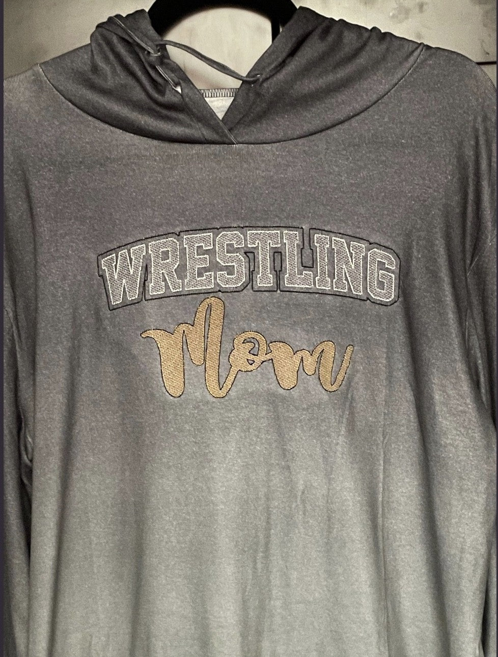 Gray hooded top embroidered with Wrestling Mom lettering