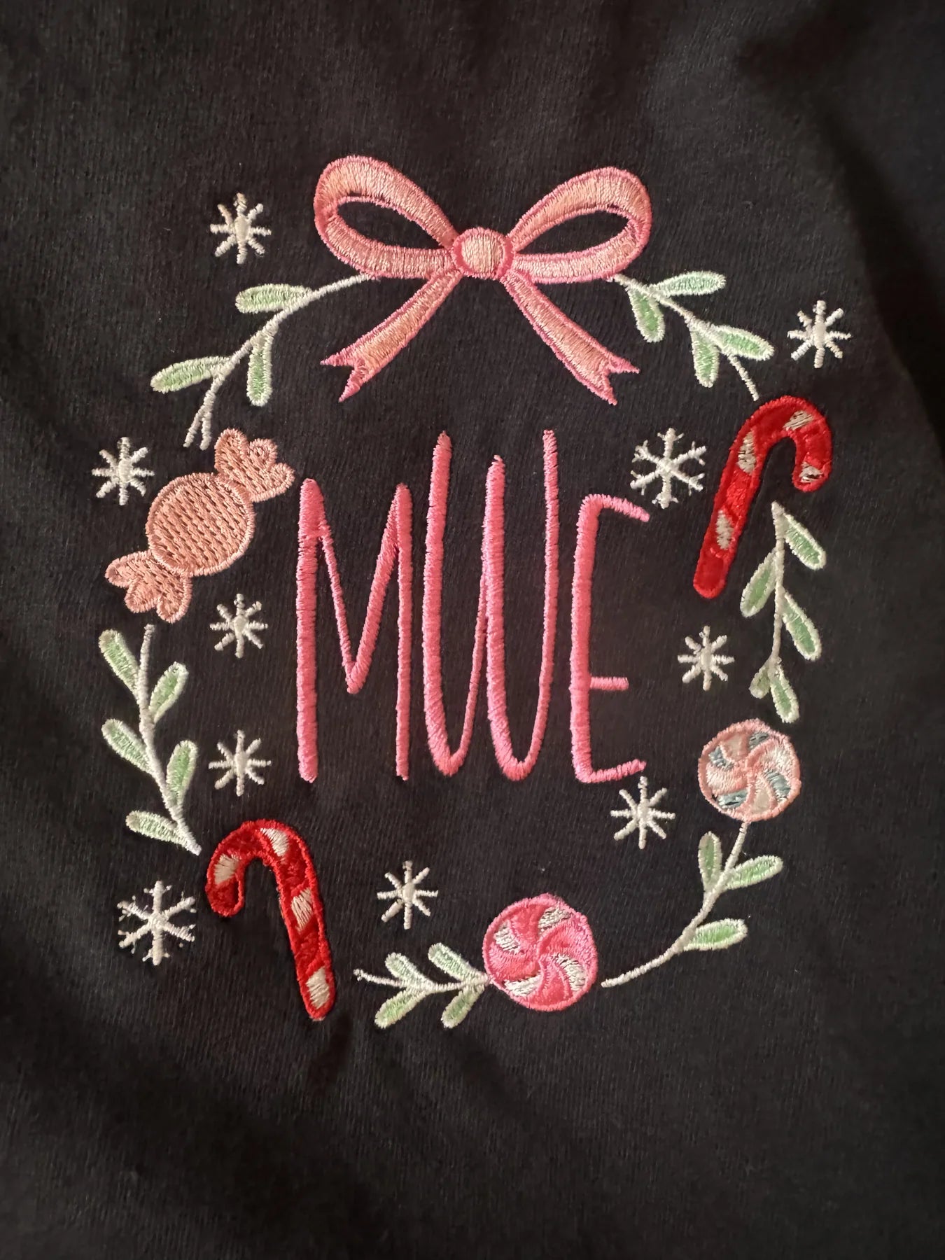 Holiday wreath embroidery with pink bow and candy cane details